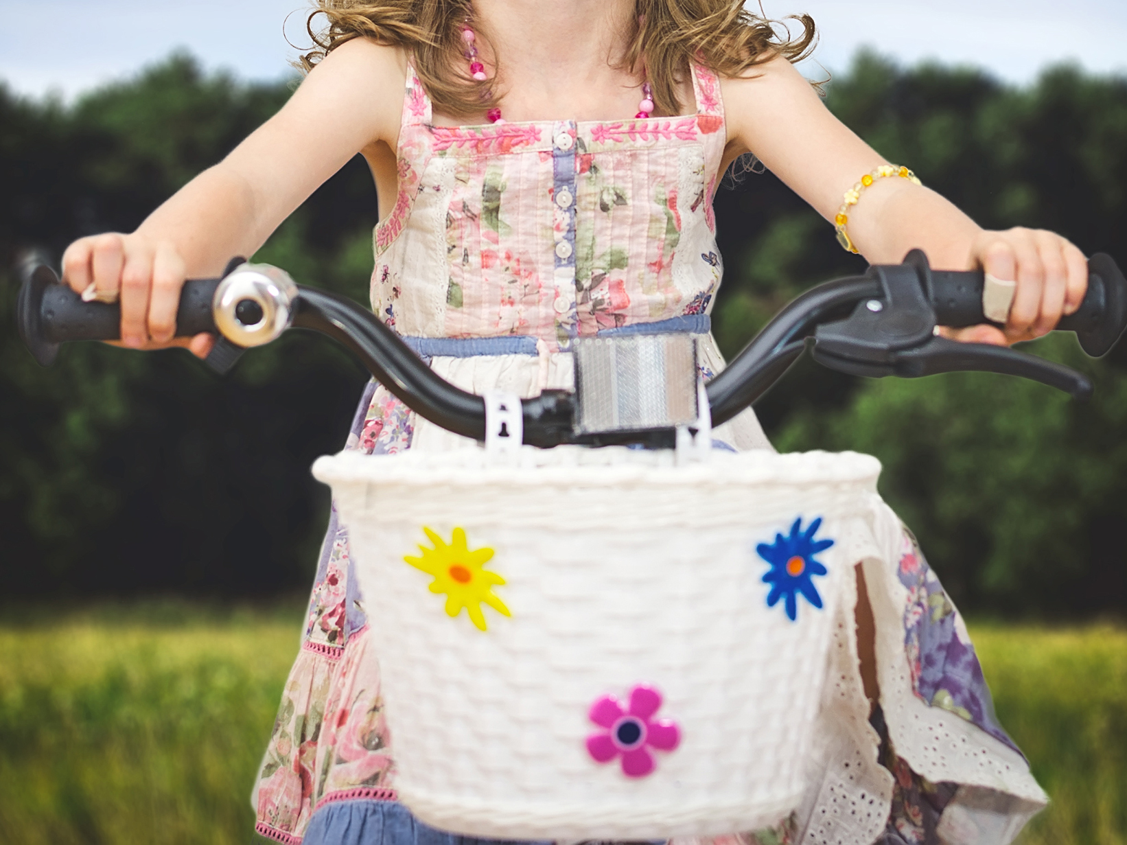 Girl on a bike with a wicker basket