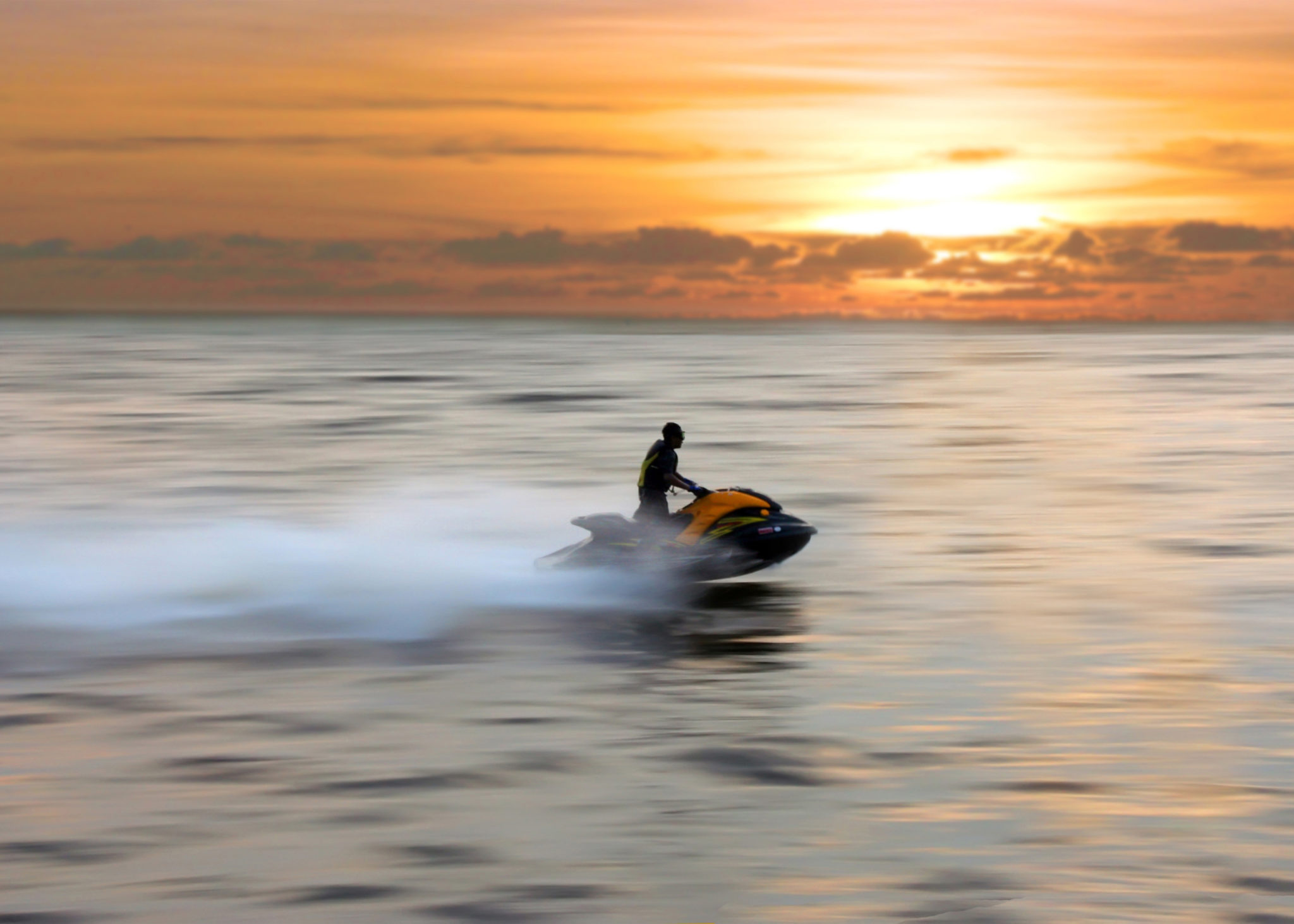 Riding a jet ski at sunset