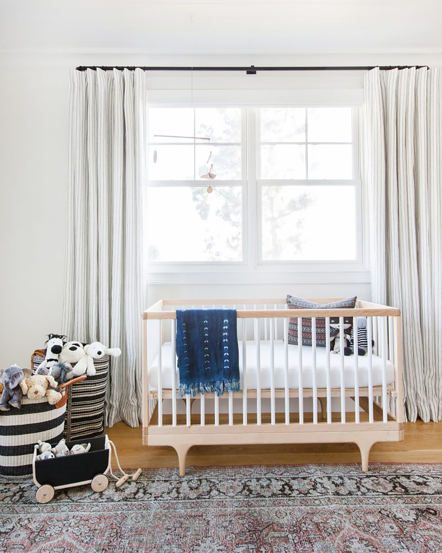 Baby bed and plush toys in nursery