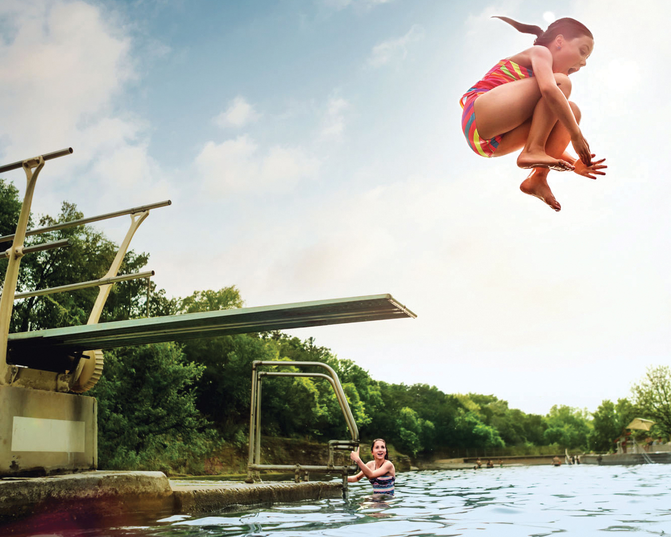 Girl jumping off a diving board