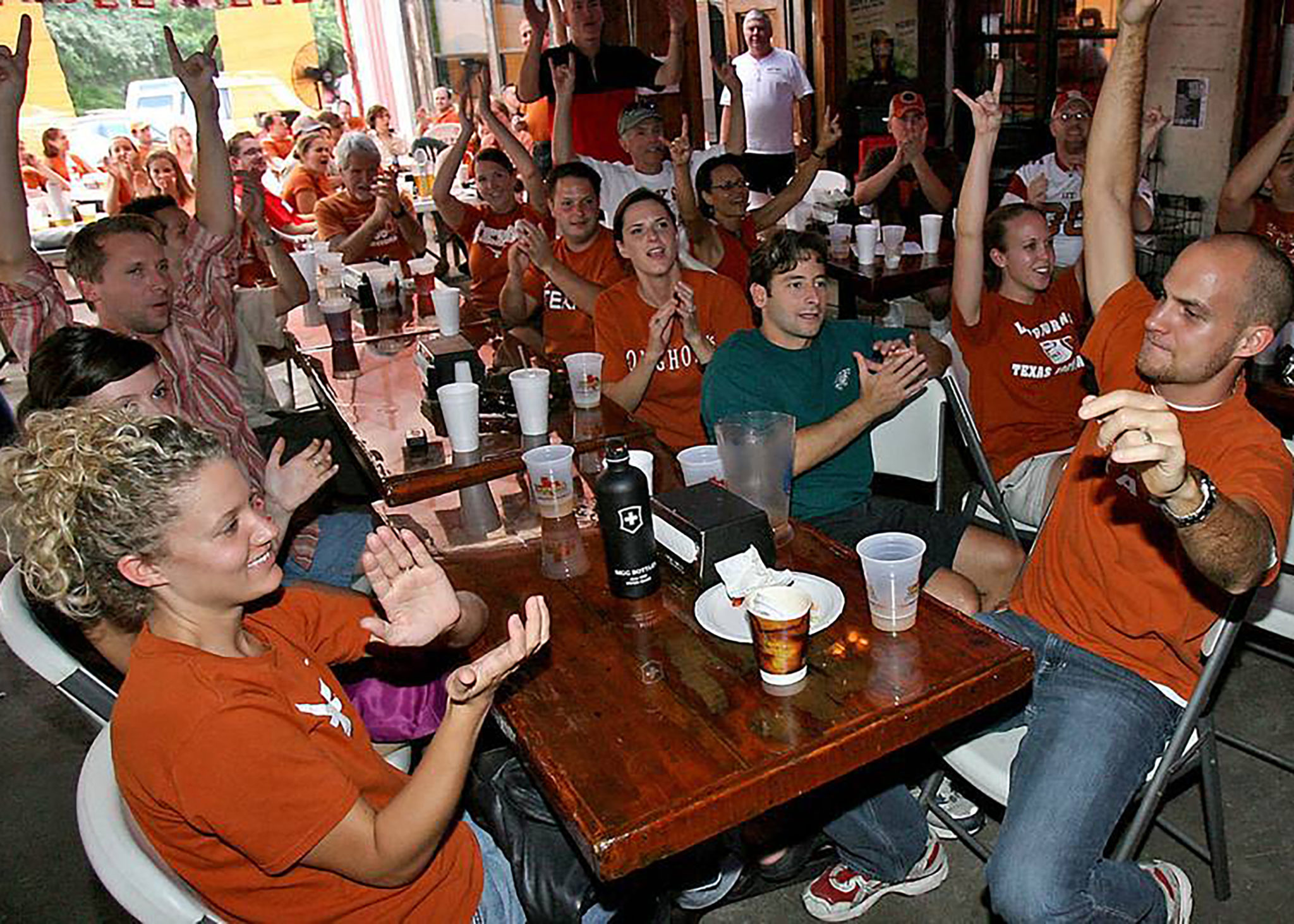 People watching UT football game at a bar