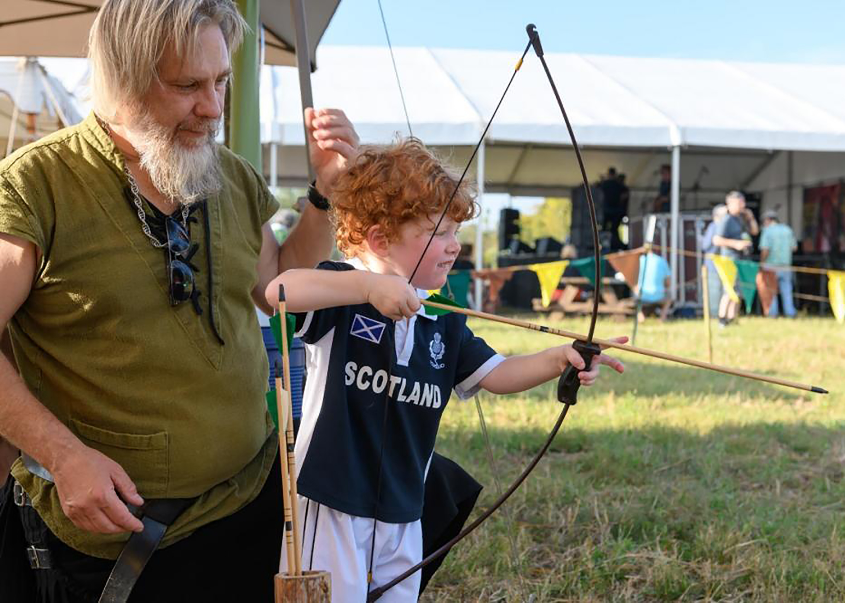 Child shooting a bow and arrow